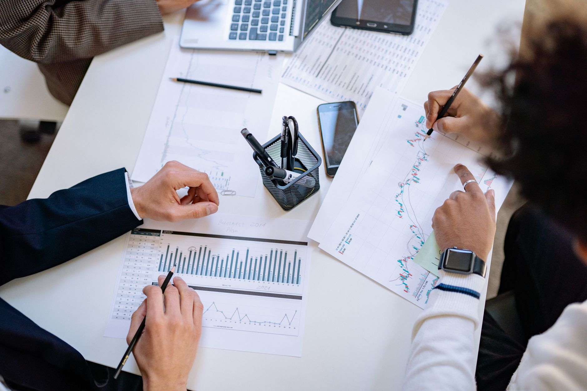 Business team analyzing financial charts and graphs during a collaborative meeting. — Choose IVG for Reliable Flavour Intensi