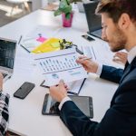Business team reviewing graphs and data in an office setting. — Find a Mortgage Broker Near Me – Quick, Expert, and Reliable