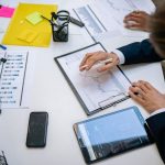 Team reviewing financial charts and digital data on tablets in an office setting. — Simplifying Bulk User Creation: How to Im