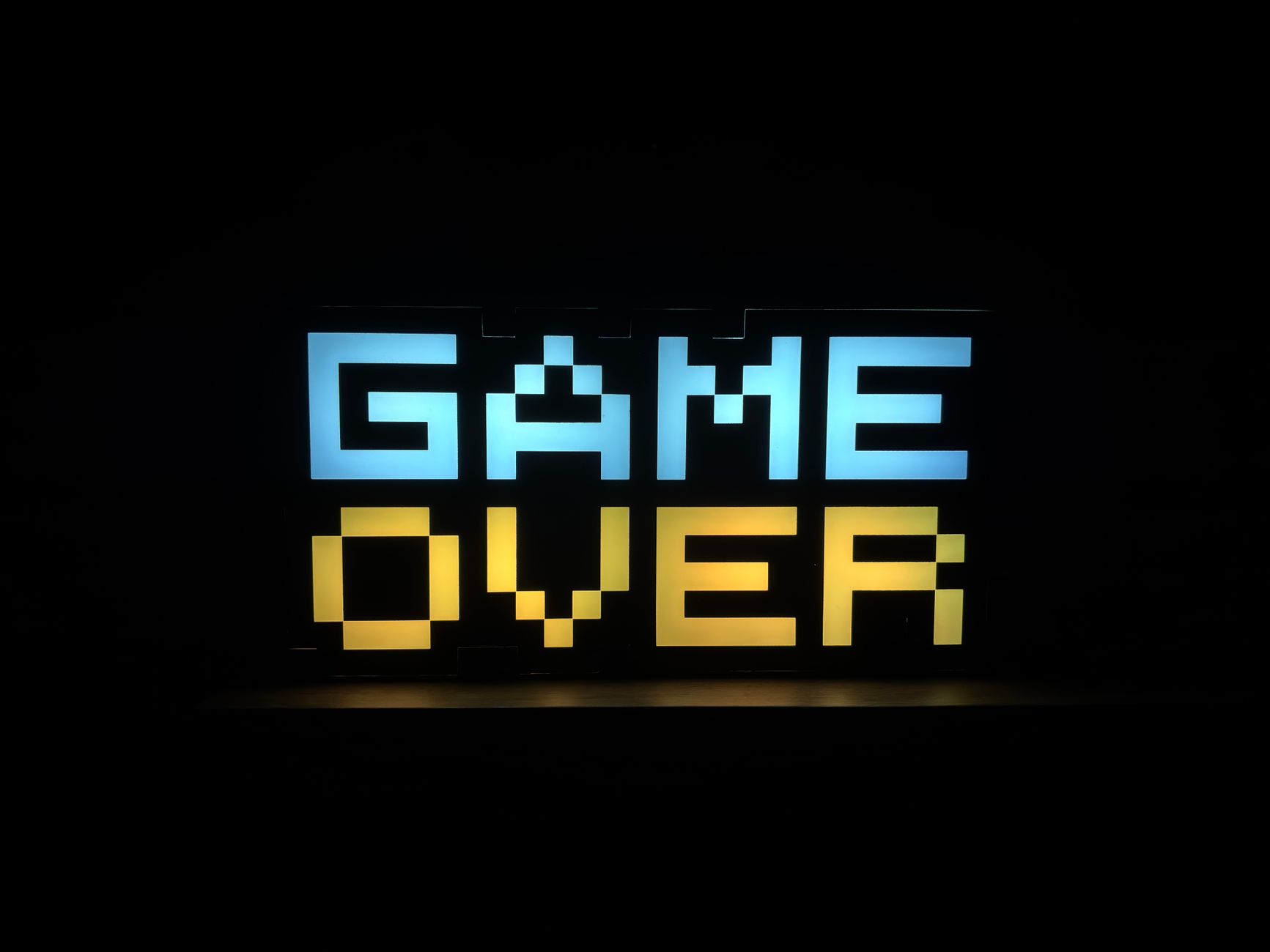 Illuminated pixel art 'Game Over' sign with vibrant colors against a black background. — The Role of Eat and Run Verification
